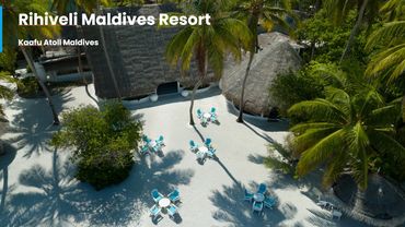 Rihiveli Maldives Resort with beach seating and palm trees in Kaafu Atoll.