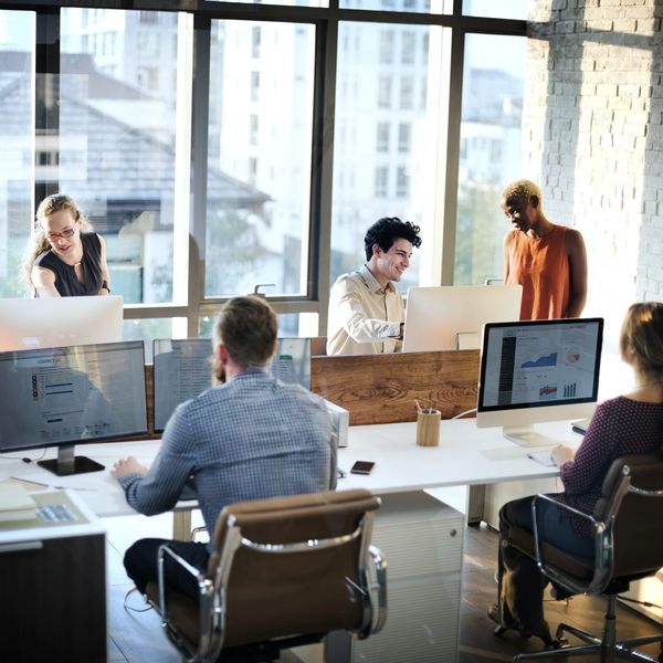 A team of people working in an office with computers