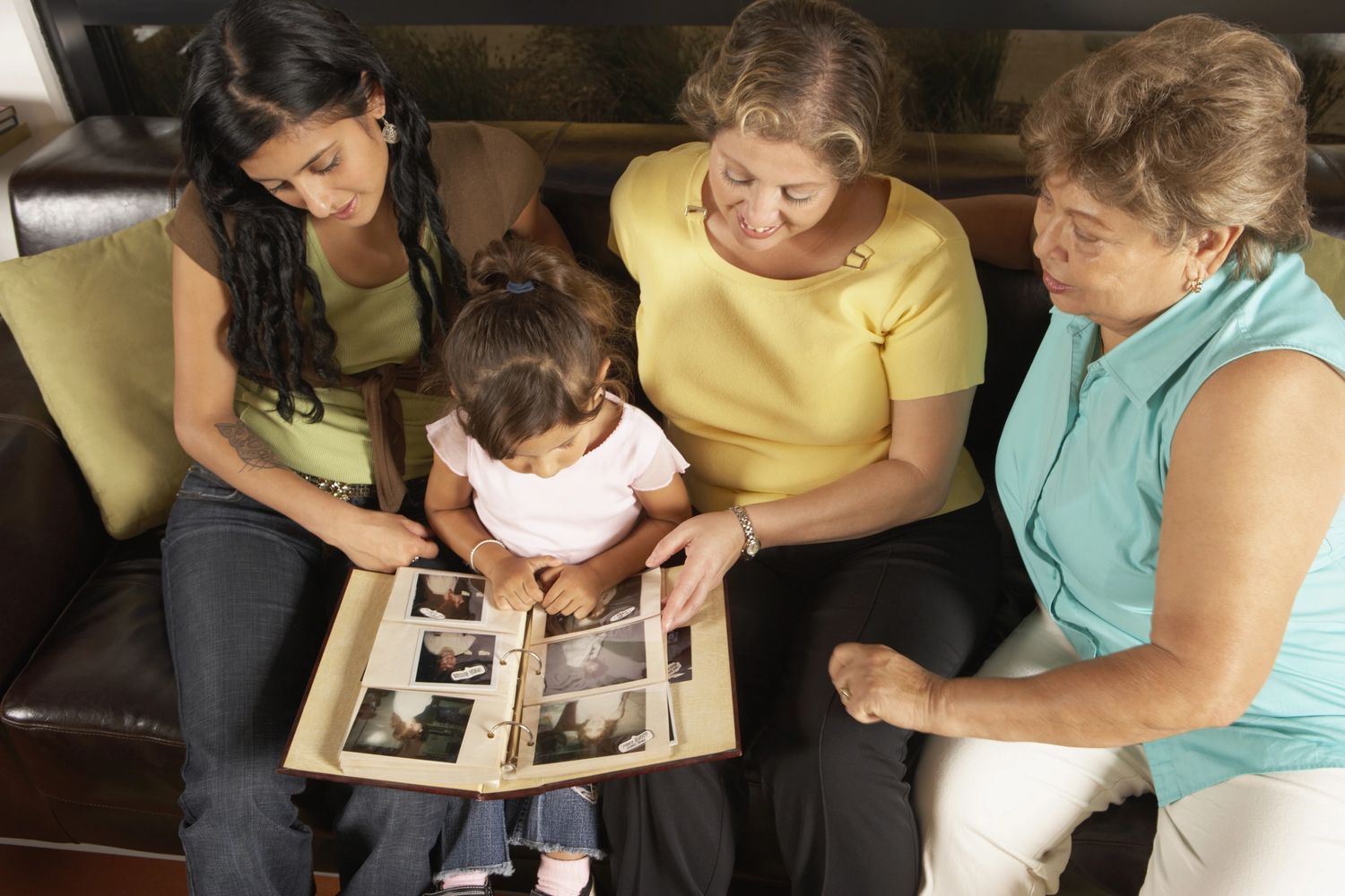 Multiple generations enjoying looking at the past through photo albums