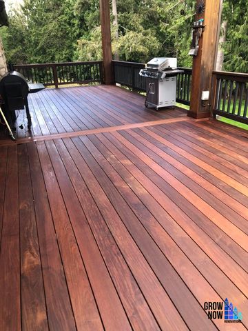 Wooden deck with grills and railing.