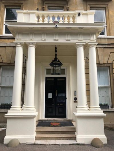 Columns and entrance of a building with a hanging lantern.