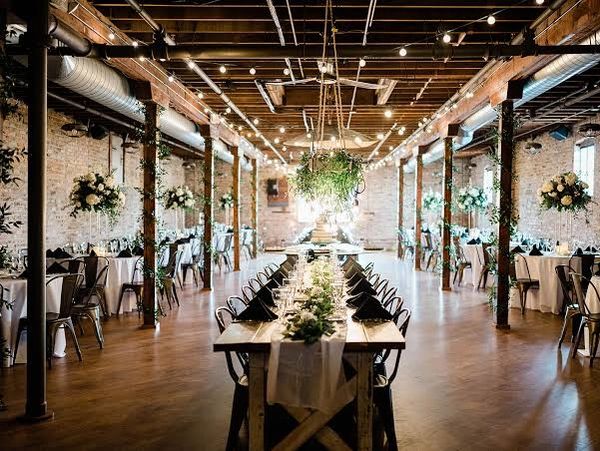 Elegant wedding reception setup in rustic venue.