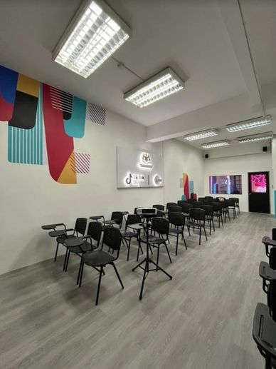 Modern classroom with colorful wall accents and TikTok branding.