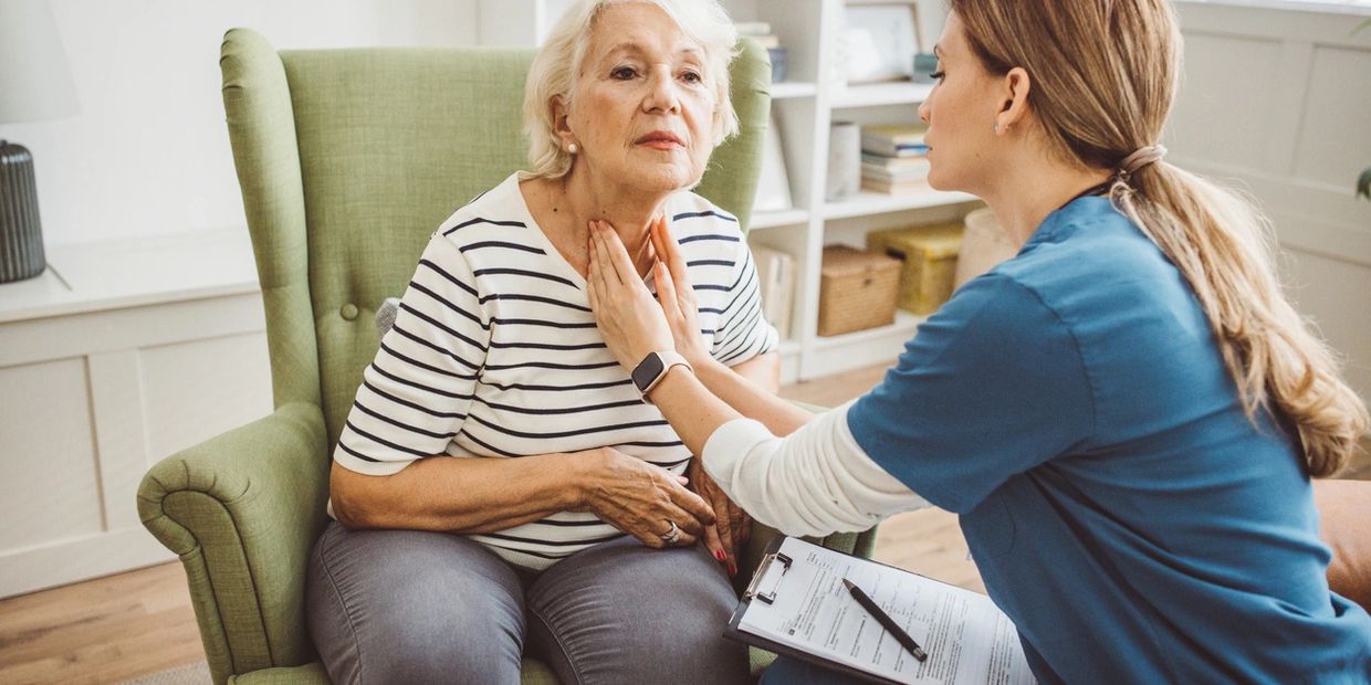 Medical professional examining an elderly woman.