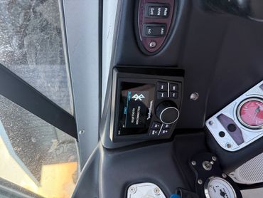 A control panel with gauges and a Rockford Fosgate Bluetooth device.