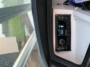 Boat stereo system with Bluetooth connected, surrounded by boat equipment.