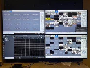 Four surveillance monitors showing many offline and unknown devices.