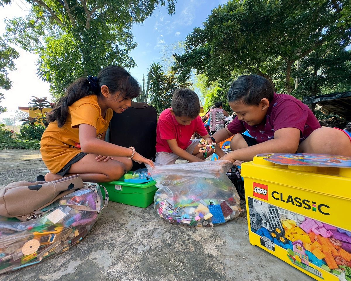 Maya children receiving toy donations.