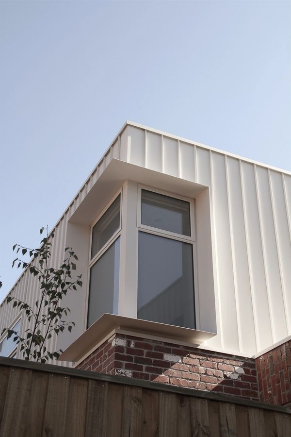 Cuthbert exterior photograph in Reservoir, with recycled red brickwork and light-coloured cladding.
