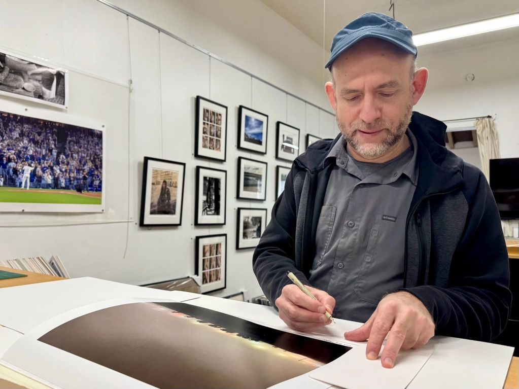 Signing an editioned piece before framing at The Perfect Exposure Studio in Alhambra, CA.