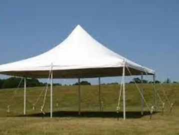 A white canopy tent set up outdoors on a grassy field under a clear blue sky.
