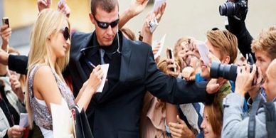 A close Protection Officer protecting a celebrity
