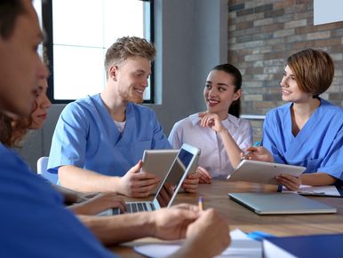 Group of smart medical students with gadgets in college