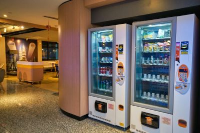 Two vending machines inside a modern indoor space.