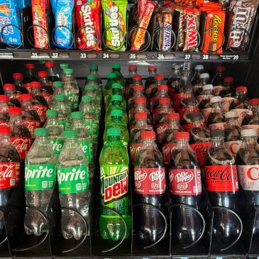 Vending machine with soda bottles and candy bars.