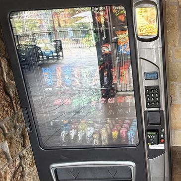 Vending machine in a stone-walled area.