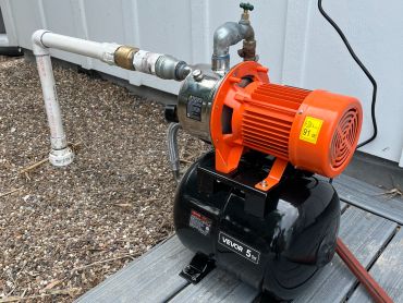 Finished shallow water well system designed for residential sprinkler irrigation, installed in a coa