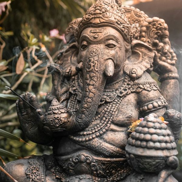 Ganesh sculpture with burning incense