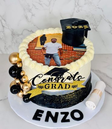 Graduation cake with photo, black and gold decorations, and "Congrats Grad" text.