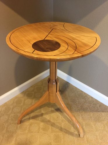 Three-legged table made from cherry and black walnut.