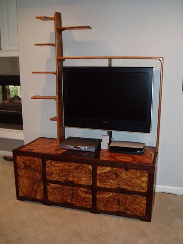 Made with maple, maple burl and black walnut. The TV hangs from the center post and swivels.