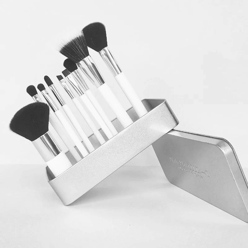 a set of self standing magnetic makeup[ brushes in a metal storage tin,  placed at a 45 degrees