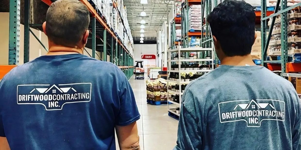 Driftwood Contracting team members walking through a warehouse during a work project.