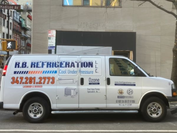 R.B. Refrigeration service van on city street.