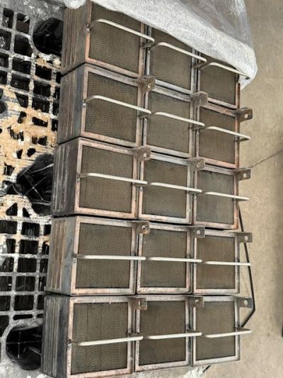 Stack of metal air filters with braces.