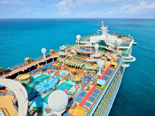 Aerial view of a cruise ship with pools and recreational areas.