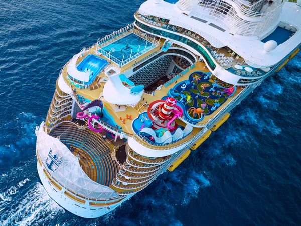 A large cruise ship with pools and water slides.
