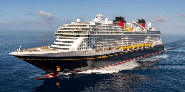 Large Disney cruise ship sailing on the ocean.