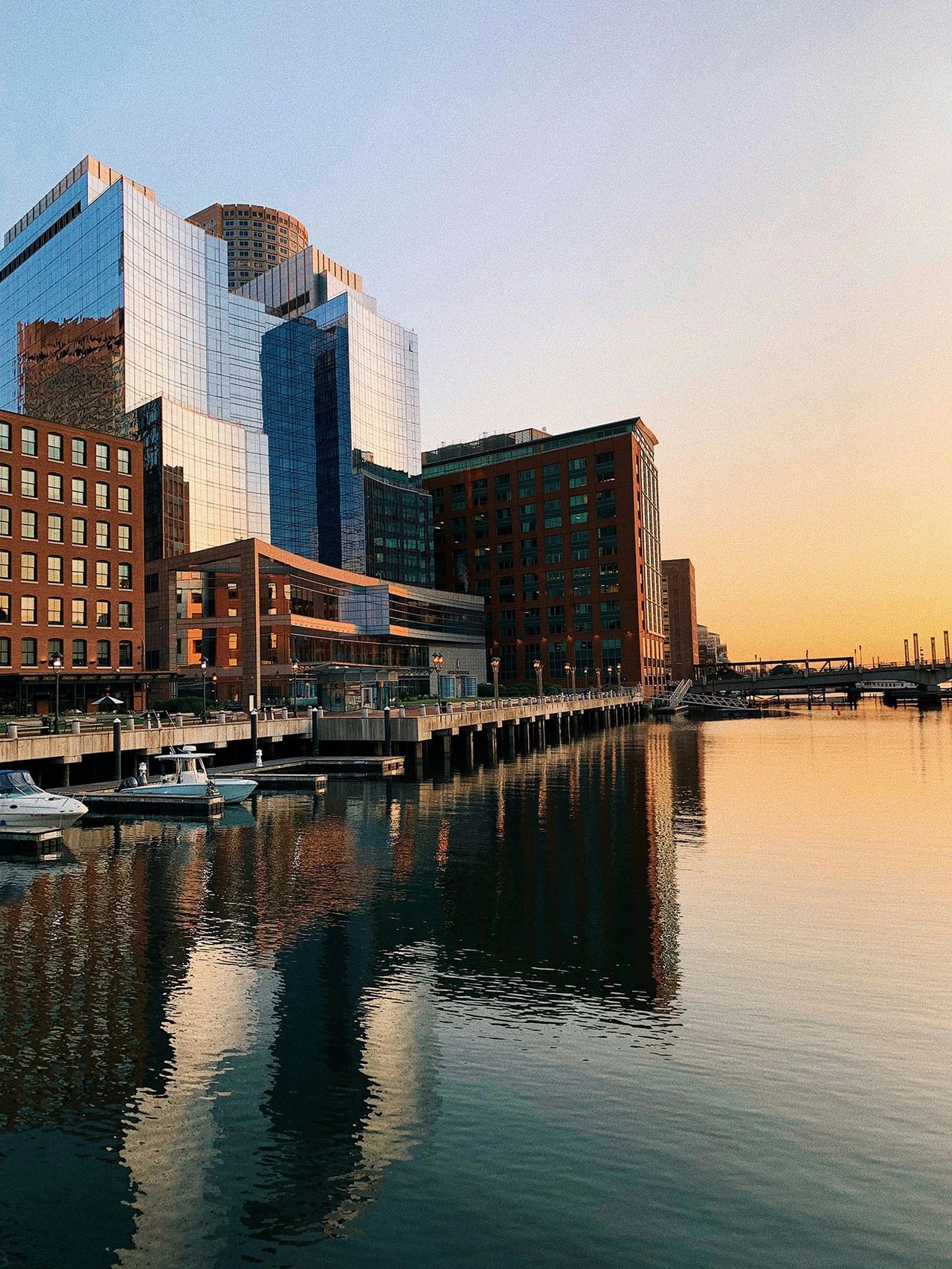 The Boston Seaport comes alive at golden hour, reflecting modern architecture and city lights on the calm harbor waters. This thriving waterfront district is known for its sleek skyscrapers, trendy restaurants, and vibrant nightlife. Whether you're strolling along the Harborwalk, dining at a waterfront restaurant, or enjoying the view from a rooftop bar, the Seaport is one of Boston’s most picturesque and must-visit neighborhoods. The Boston Seaport comes alive at golden hour, reflecting modern architecture and city lights on the calm harbor waters. This thriving waterfront district is known for its sleek skyscrapers, trendy restaurants, and vibrant nightlife. Whether you're strolling along the Harborwalk, dining at a waterfront restaurant, or enjoying the view from a rooftop bar, the Seaport is one of Boston’s most picturesque and must-visit neighborhoods.