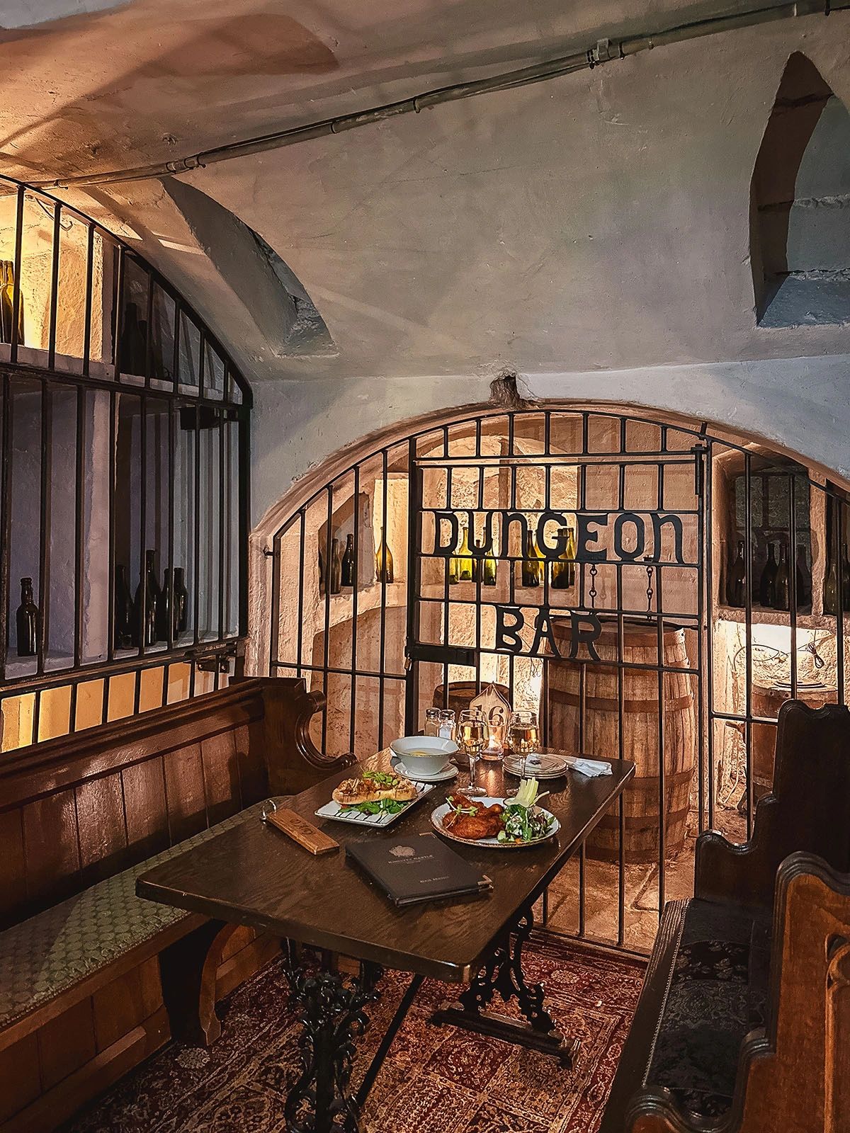 Step into Kinnitty Castle's Dungeon Bar, a one-of-a-kind dining experience set in the historic underground chambers of this Irish castle. With its arched stone ceilings, iron-gated seating, and candlelit ambiance, the Dungeon Bar transports guests back in time while offering delicious Irish cuisine and drinks. Whether you’re savoring traditional Irish dishes, enjoying a pint of Guinness, or soaking in the medieval charm, this hidden gem in County Offaly is a must-visit for travelers seeking an authentic castle experience. Step into Kinnitty Castle's Dungeon Bar, a one-of-a-kind dining experience set in the historic underground chambers of this Irish castle. With its arched stone ceilings, iron-gated seating, and candlelit ambiance, the Dungeon Bar transports guests back in time while offering delicious Irish cuisine and drinks. Whether you’re savoring traditional Irish dishes, enjoying a pint of Guinness, or soaking in the medieval charm, this hidden gem in County Offaly is a must-visit for travelers seeking an authentic castle experience.