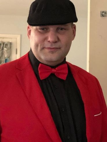 Man wearing a red suit and red bowtie