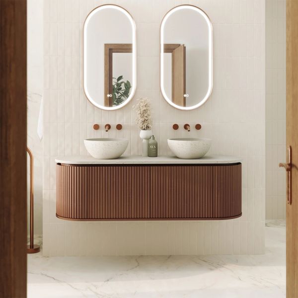 Modern double sink bathroom vanity with illuminated oval mirrors.