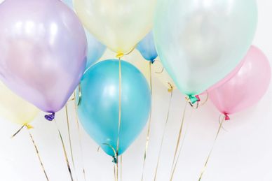 Colorful helium balloons floating.