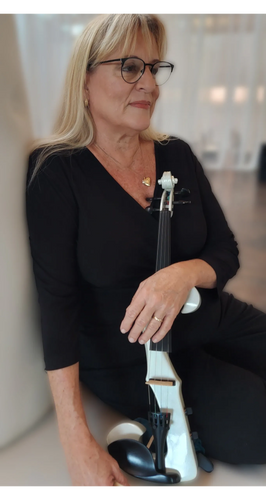 Stack of books next to pencils in a holder and a camera.