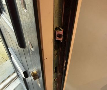 Close-up of a door lock mechanism on a wooden door.