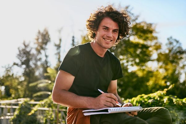 Curly-Haired Male Student Smiling after Big Score Increase on the ACT. Walker Test Prep Reviews.