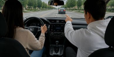 Man points ahead while woman drives a car.