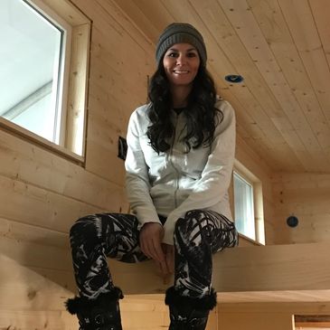 Jessica Dunkirk, sitting in a tiny house