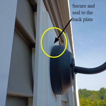 Exterior light fixture is loose and hanging and needs sealing at the backplate connection in Hampste