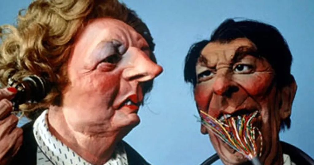 Two caricature puppets, one with a phone and the other eating wires.