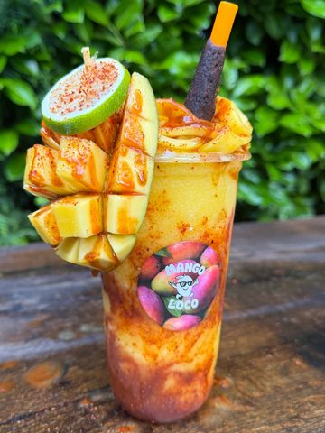 Mango-flavored drink with spicy and tangy toppings.