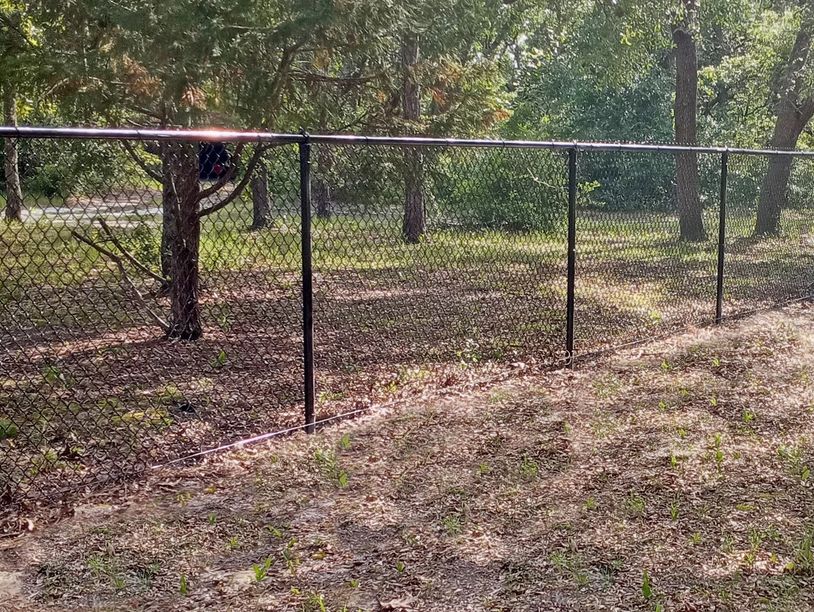 Black chain link fence on property border in Santa Rosa, FL