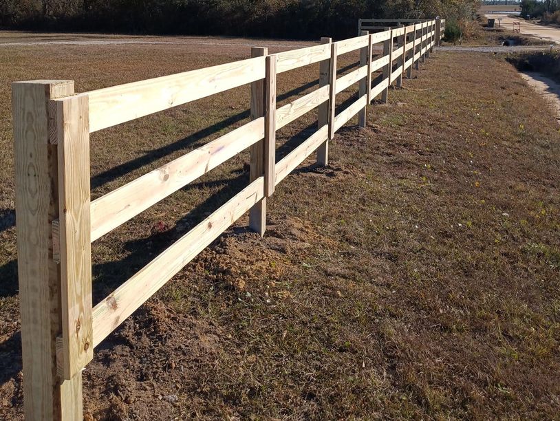 Wooden 3-rail ranch style fence painted white on property in Marianna, FL