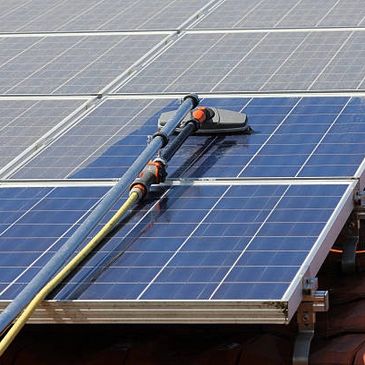 Cleaning a solar panel with a robotic device.