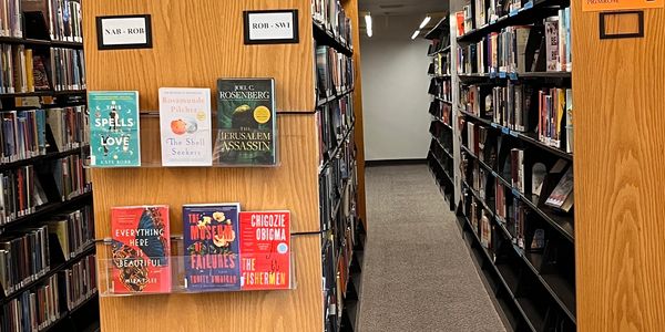 An aisle between the library bookshelves.