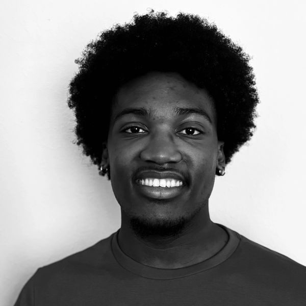 Black and white portrait of a smiling young man.